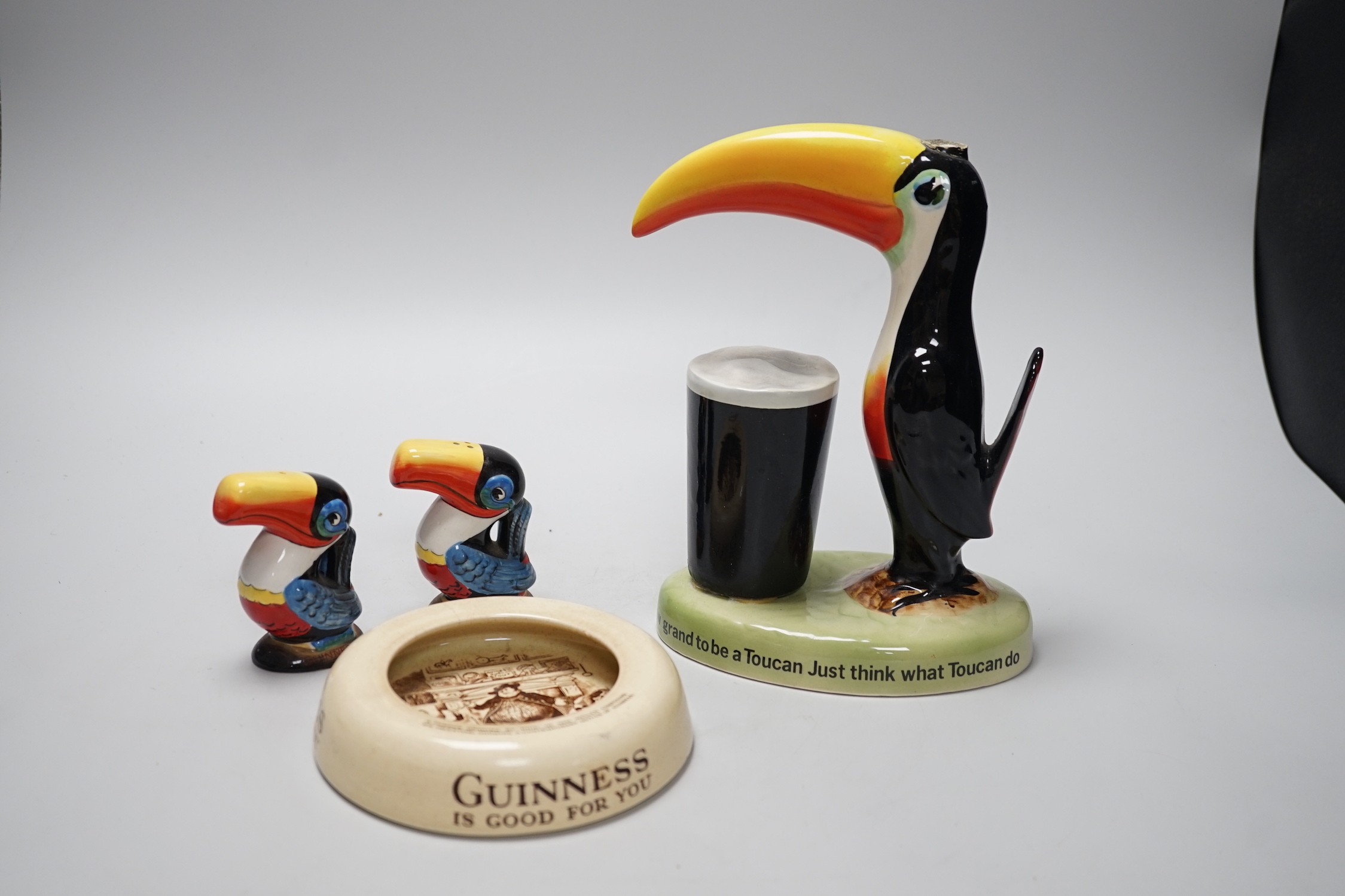 A Guinness toucan lamp-stem, 26cm high, and three related items